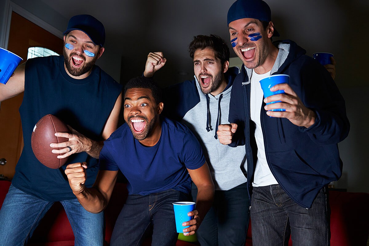 American football fans watching TV