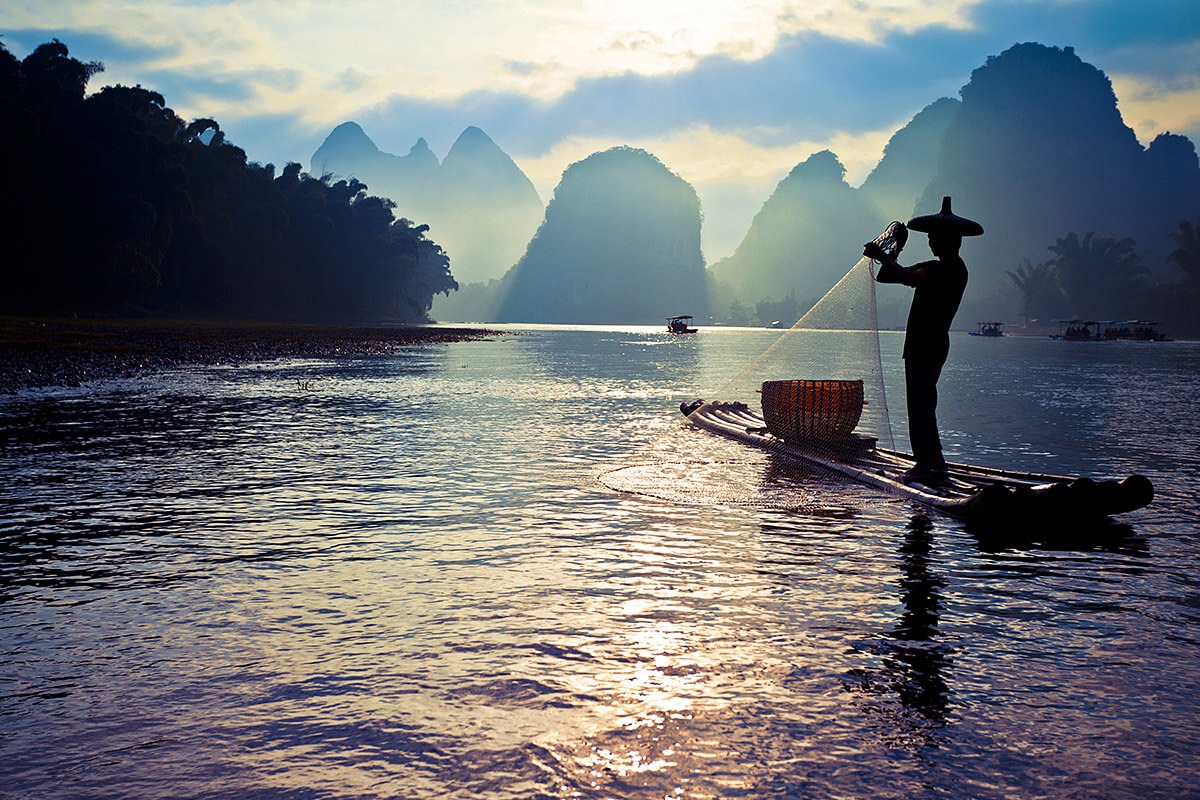 Asian man fishing with a net Asian man fishing with a net