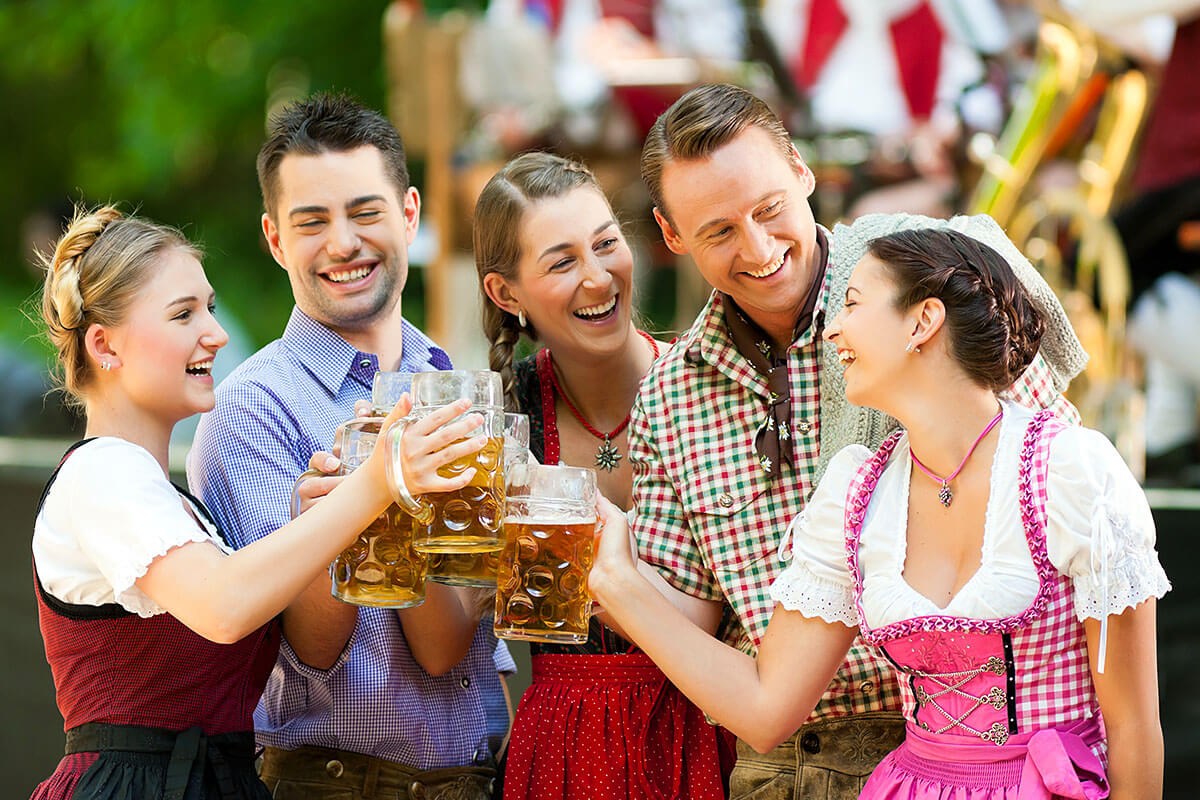 Cheerful company of people raise beer mugs on holiday - Oktoberfest, Germany Cheerful company of people raise beer mugs on holiday - Oktoberfest, Germany
