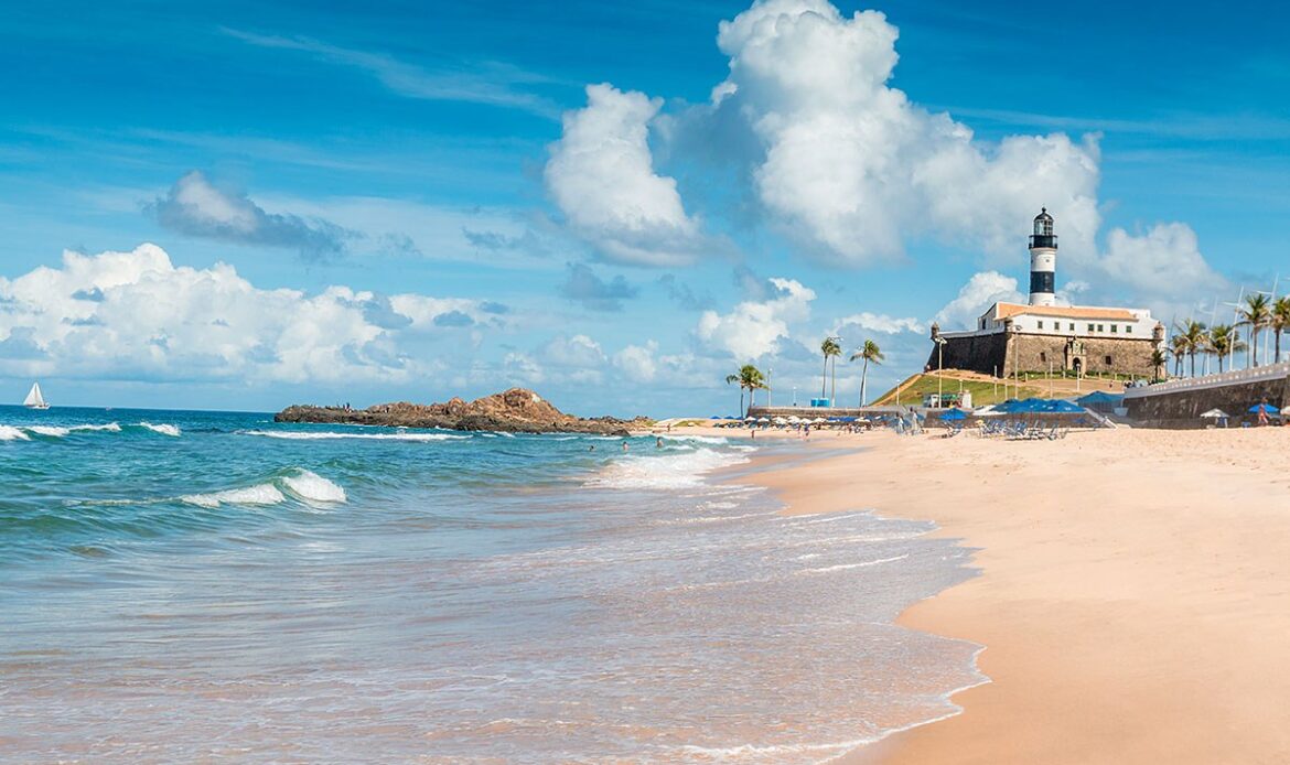 View of the beach and Farol da Barra in the city of Salvador, Brazil