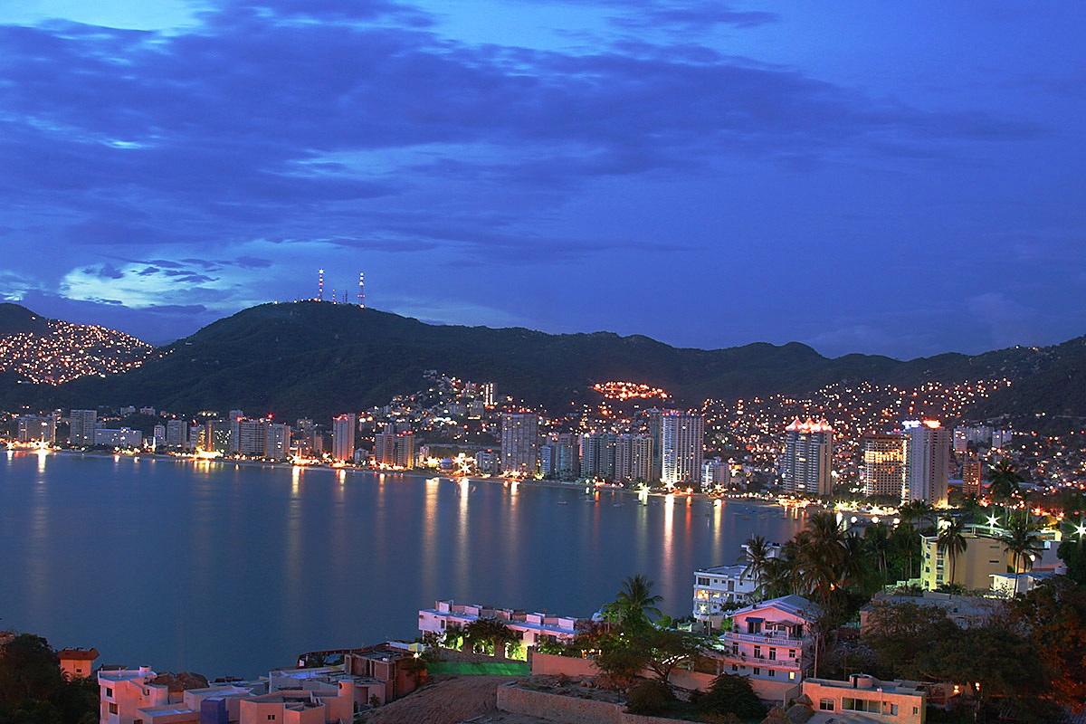 Evening view of mountains, ocean and buildings in Acapulco, Mexico Evening view of mountains, ocean and buildings in Acapulco, Mexico