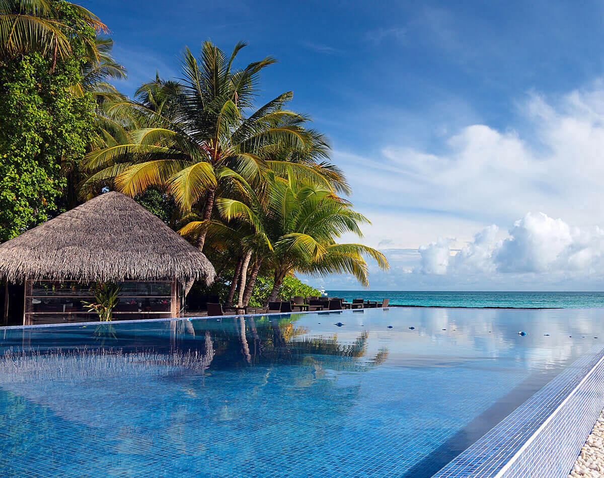 Image of palm trees, pool and ocean, Kuramathi, Maldives Image of palm trees, pool and ocean, Kuramathi, Maldives
