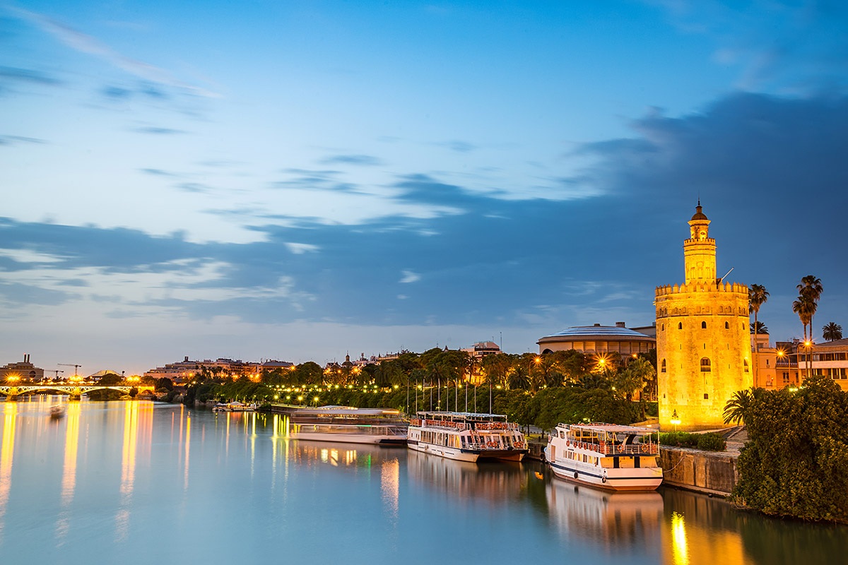 View of the Guadalquivir River and the Golden Tower at sunset, Seville, Spain