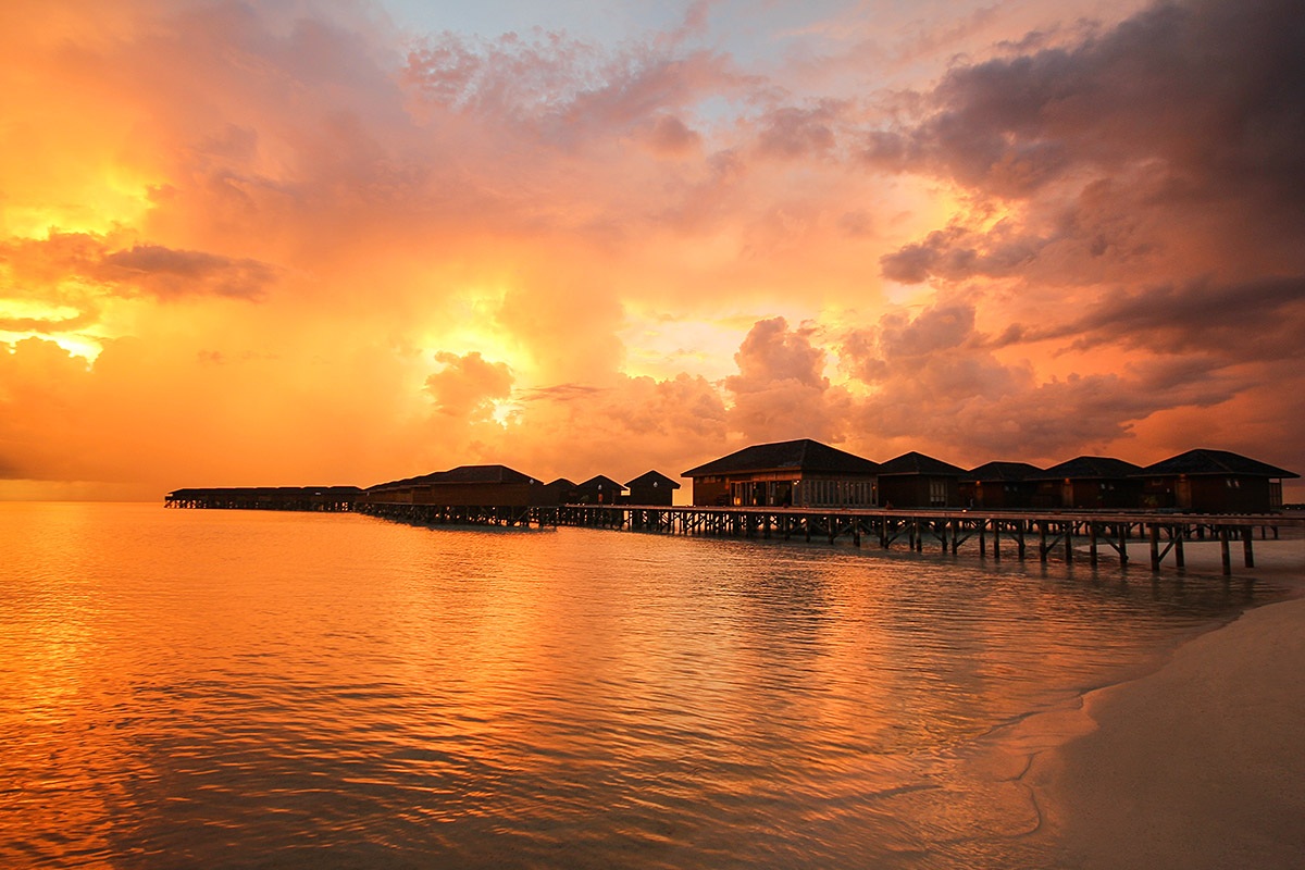 Views of the Indian Ocean and Bungalows at the time of sunset, Island of Vilamendhoo