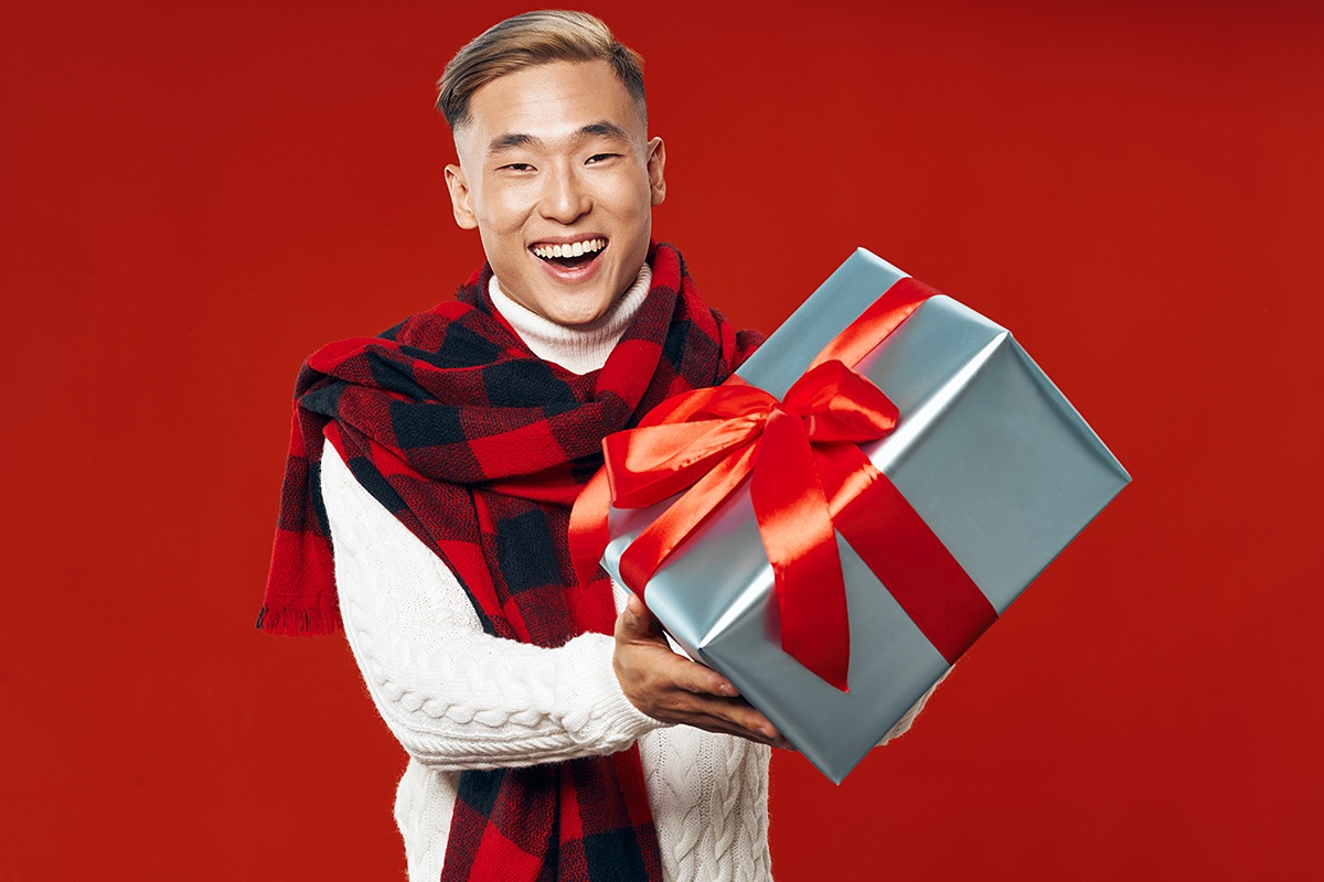 Asian man with big gift in his hands Asian man with big gift in his hands