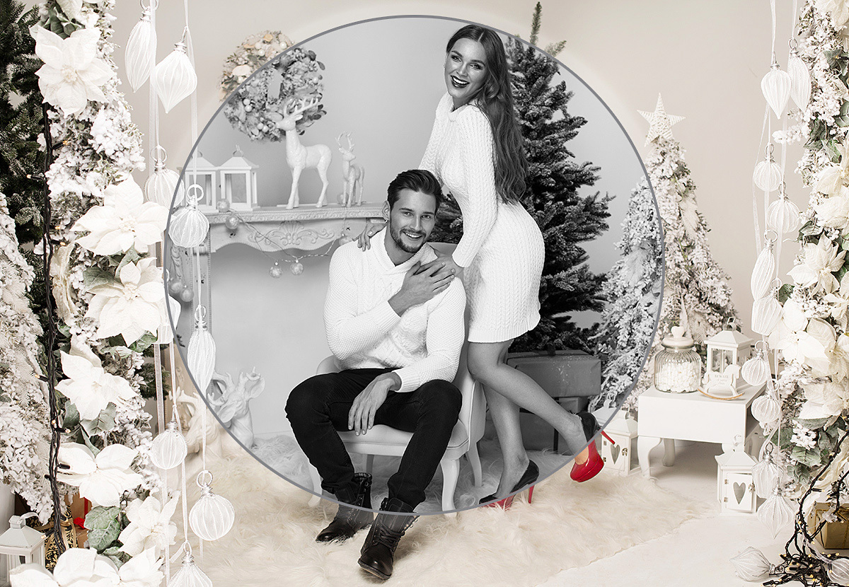 Young couple in love on New Year's Eve by the Christmas tree Young couple in love on New Year's Eve by the Christmas tree
