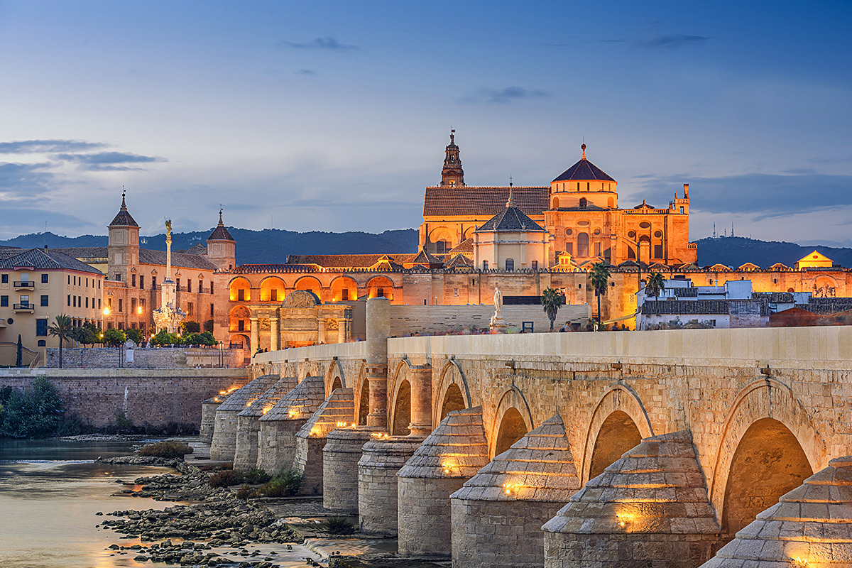 Evening view of the old Roman bridge and Mosque in Cordoba Evening view of the old Roman bridge and Mosque in Cordoba