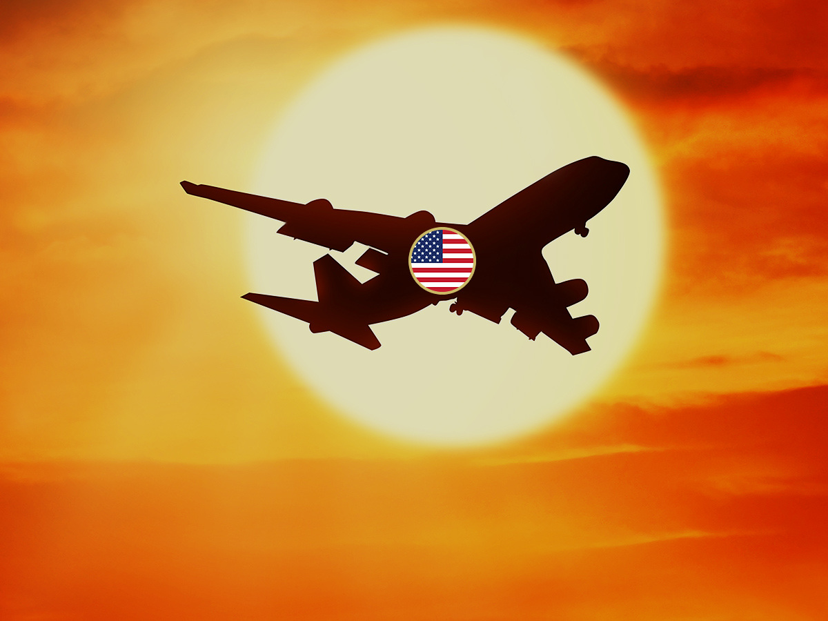 Airplane flies at sunset