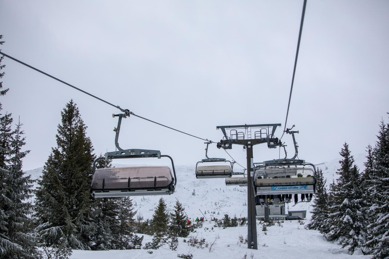 This atmospheric photograph captures the essential infrastructure that makes modern ski resorts function.