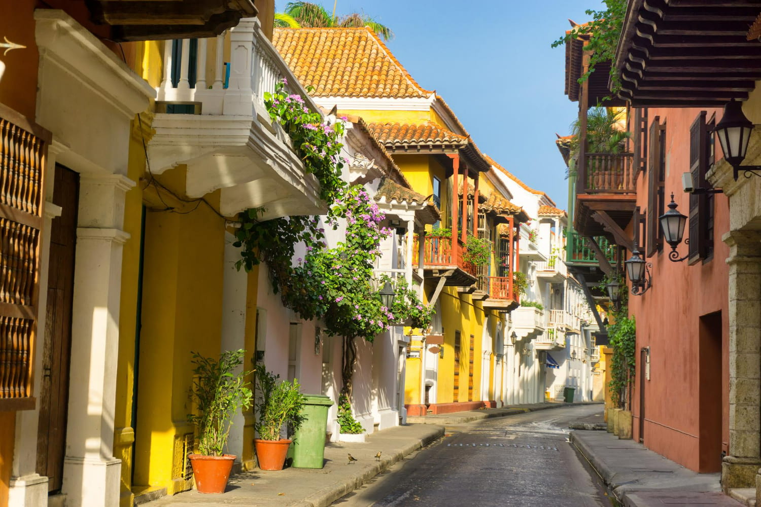 This captivating photograph showcases a charming cobblestone street in Cartagena's historic Old Town, featuring the city's iconic colonial architecture and vibrant palette of colors.