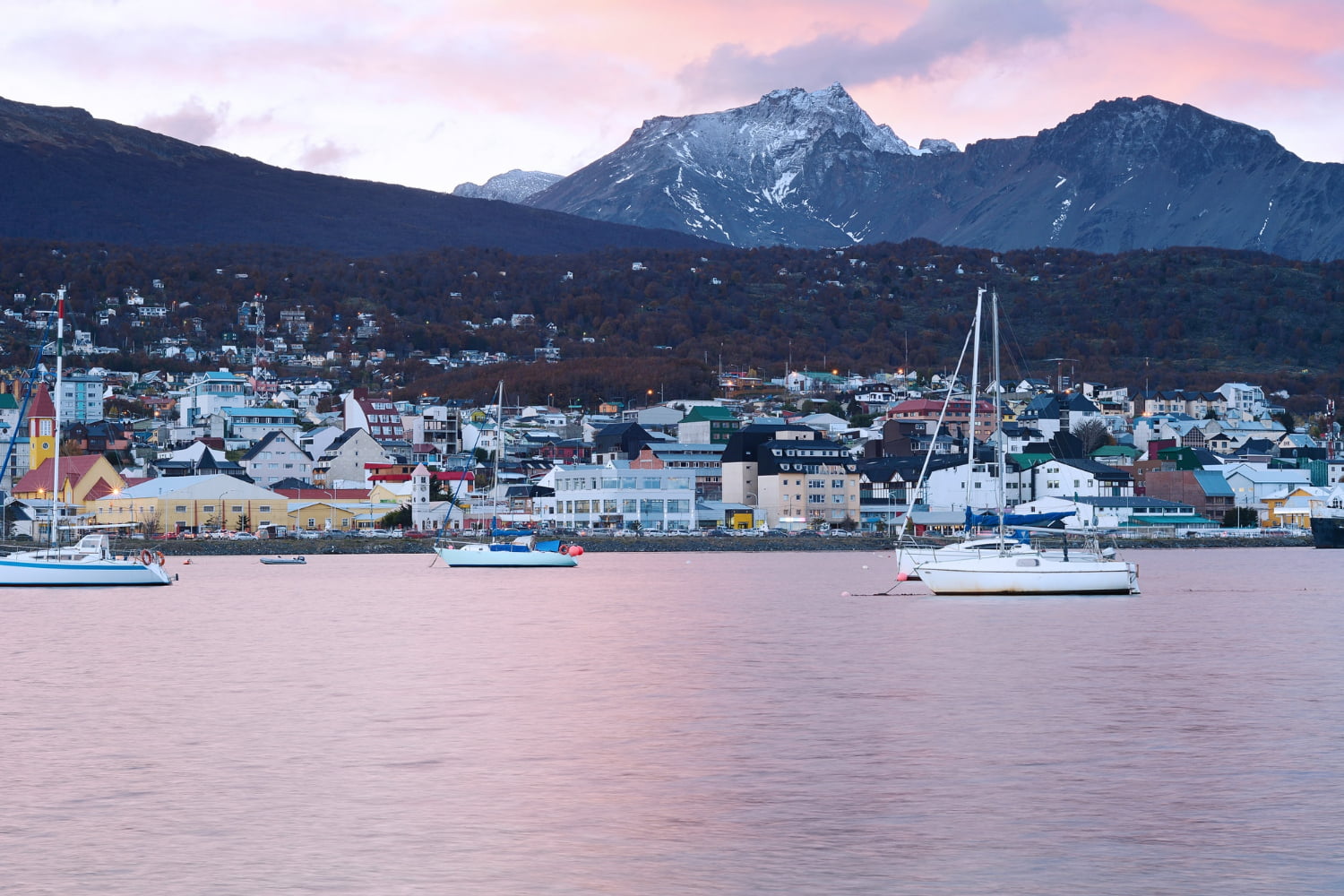 This stunning photograph captures Ushuaia, Argentina, during the magical golden hour—likely at sunrise or sunset.
