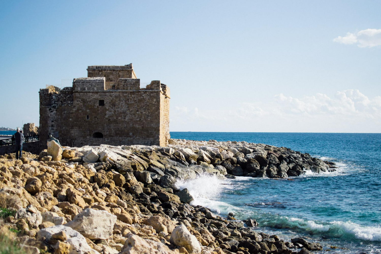 This imposing medieval fortress tower stands sentinel on a rugged rocky headland, commanding views of the Mediterranean Sea.