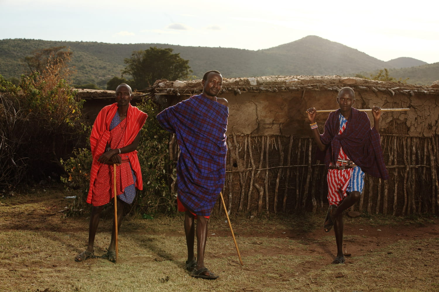 Each figure stands with characteristic poise, holding wooden staffs or walking sticks that serve both practical and symbolic purposes in their pastoral lifestyle.