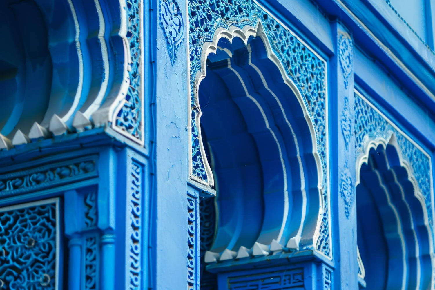 This stunning close-up photograph reveals the extraordinary craftsmanship and artistic precision embedded within Chefchaouen's architectural details.