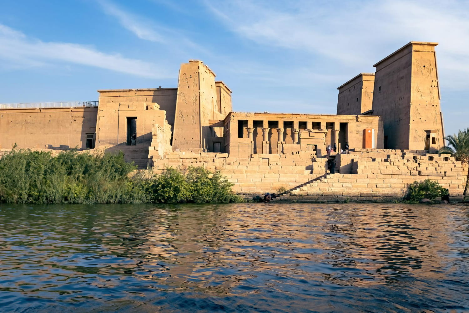 The composition showcases the temple as it has stood for millennia, framed by the eternal waters of the Nile River.
