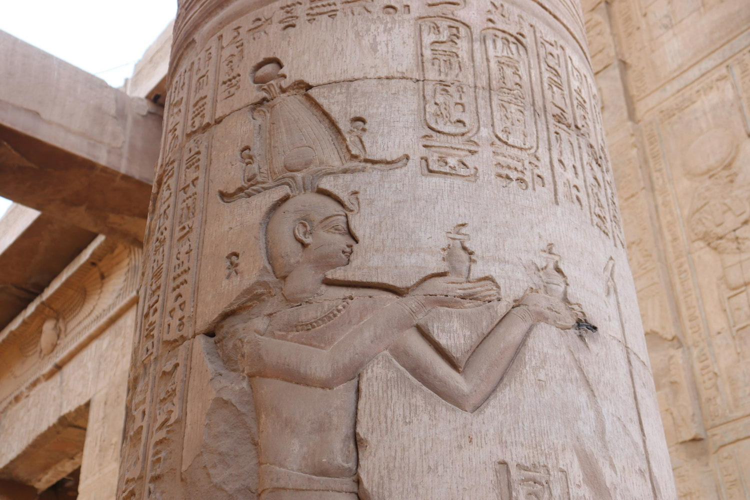 The most striking feature is a life-sized profile of a pharaoh or deity, rendered with elegant simplicity and remarkable psychological presence.